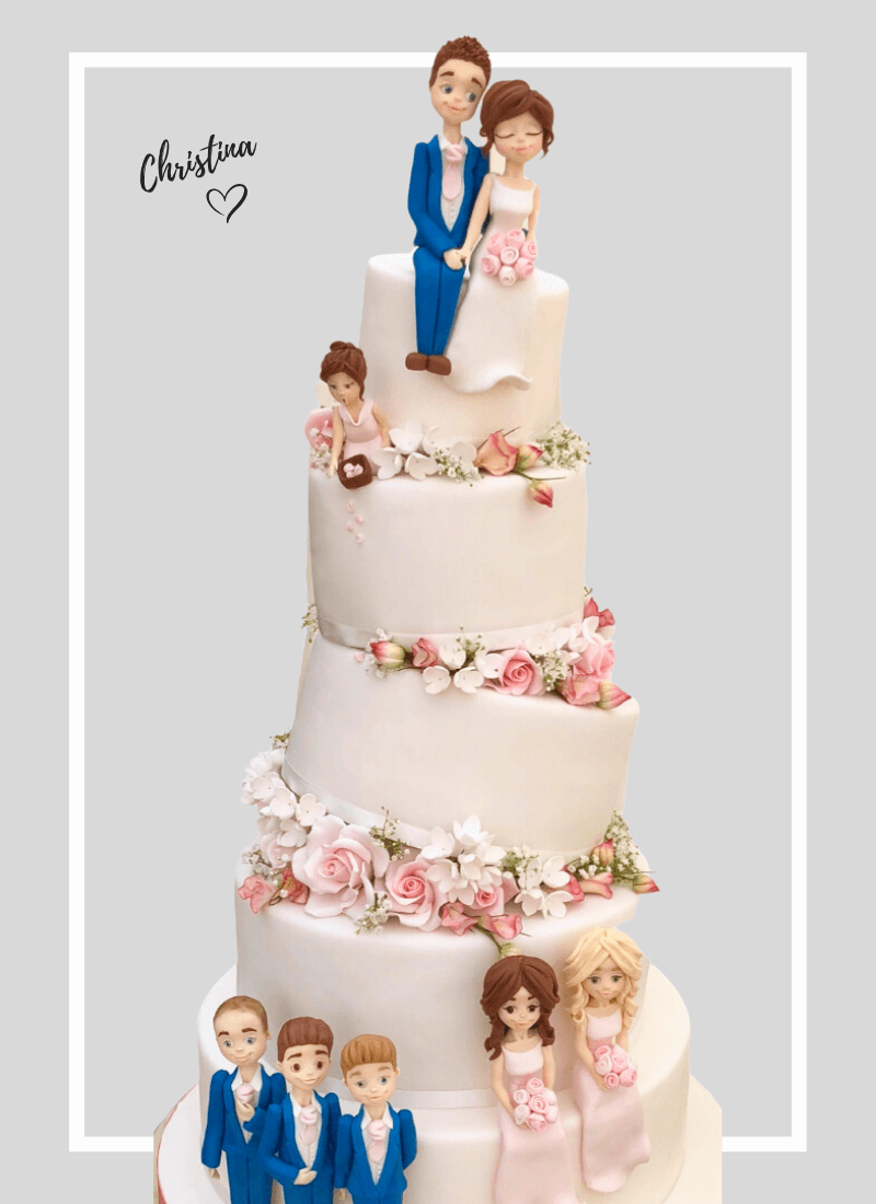 Tall fun topsy turvey tilted cake topped with handmade fondant wedding figures of bride, groom and wedding party. Including beautiful soft pink sugar roses