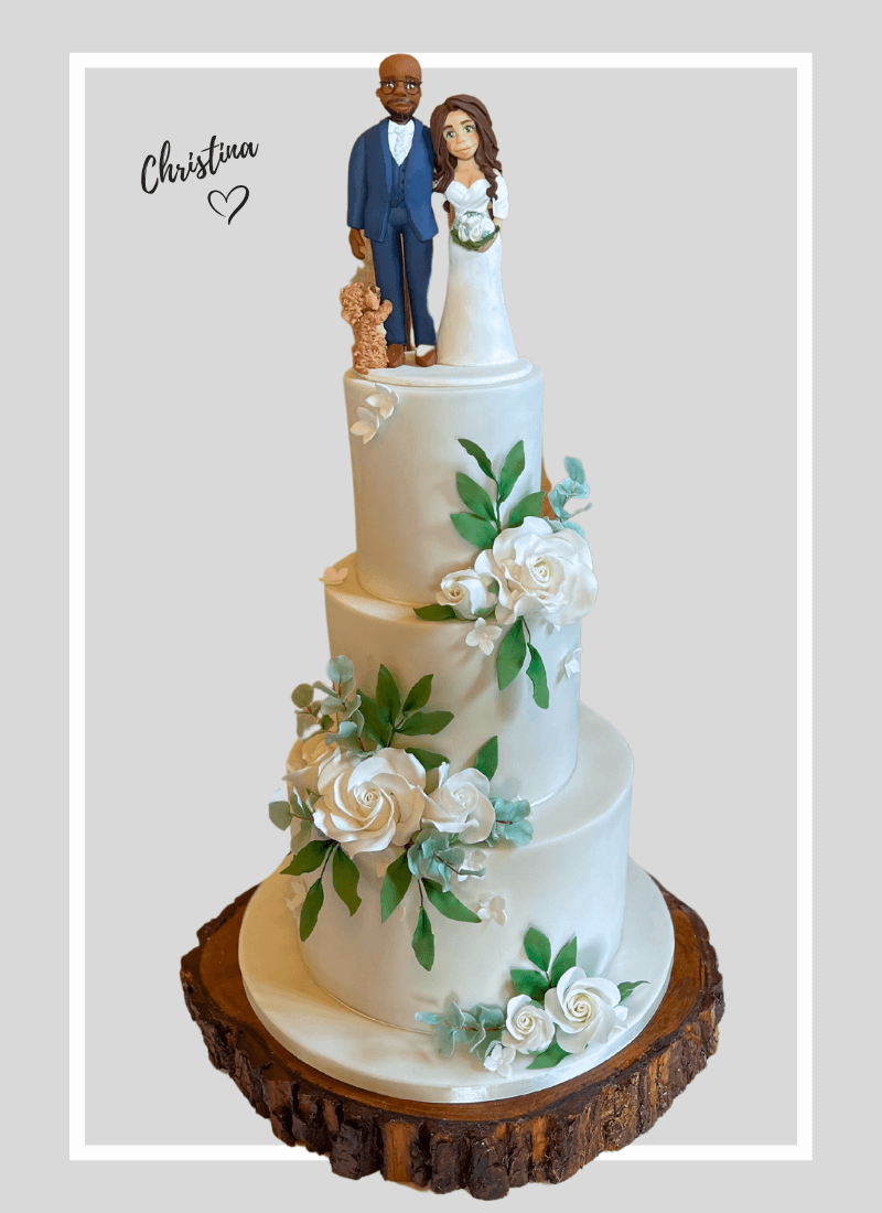 Rustic style wedding cake, with pretty white sugar rose and foliage topped with a custom made wedding cake figures with there beloved family dog