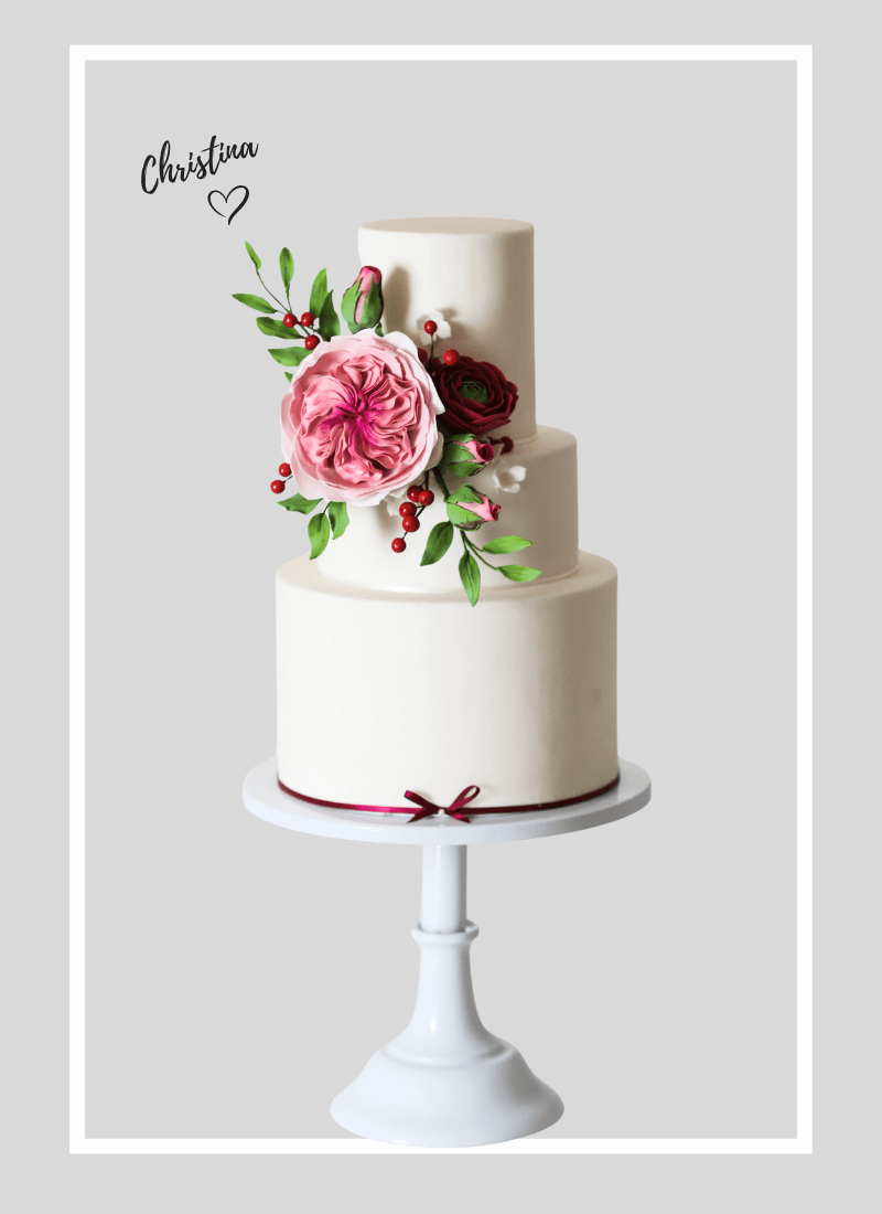Traditional elegant White bespoke wedding cake with bright colours burgundy and pink floral sugar flowers