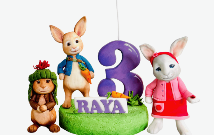 Completed Peter Rabbit cake topper on a cake."