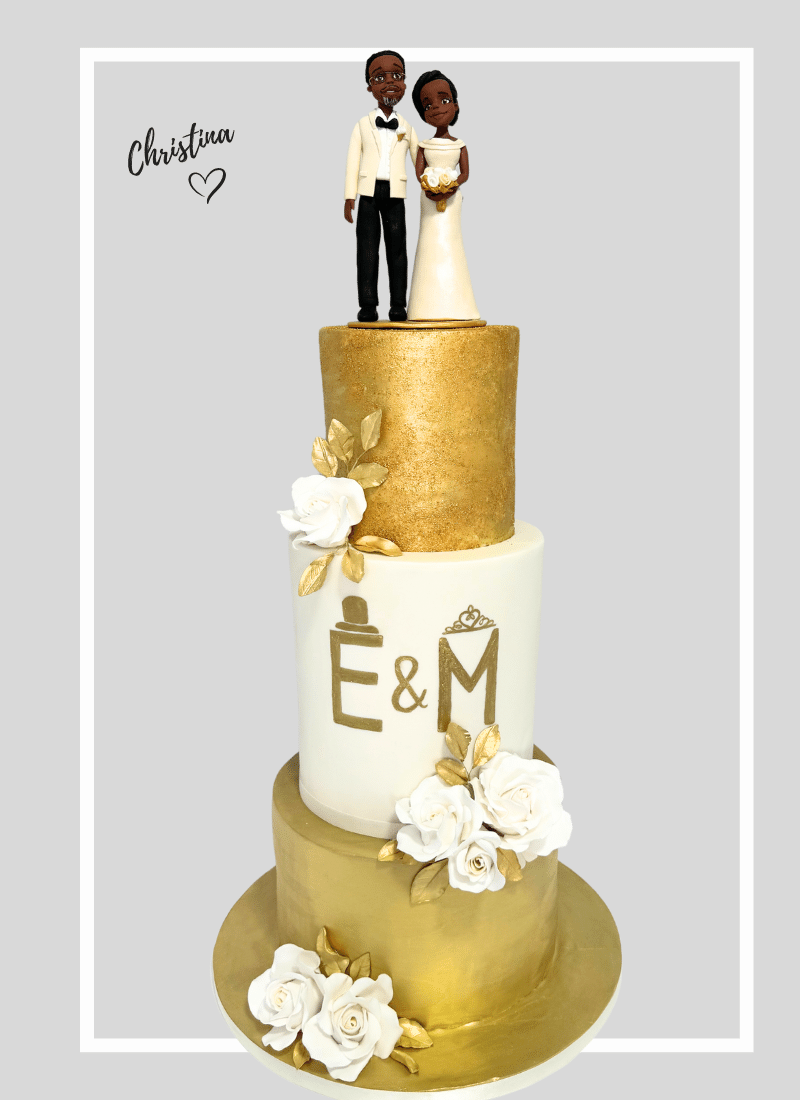 african bespoke wedding cake adorned with elegant gold and white flowers and a personalised wedding cake topper